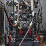 Engine testing setup with various cables attached.
