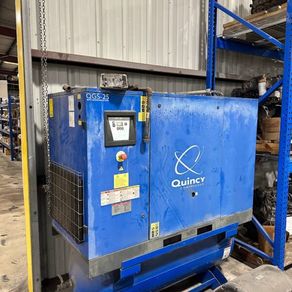 A blue machine is in the middle of a warehouse.